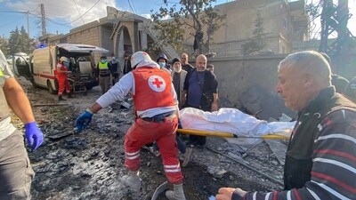 Rescuers evacuate a body at the site of an Israeli airstrike that targeted a village near the Syrian border with Lebanon (AFP) Rescuers evacuate a body at the site of an Israeli airstrike that targeted a village near the Syrian border with Lebanon (AFP)