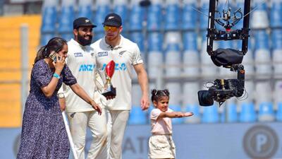 New Zealand spinner Ajaz Patel, Player-of-the-Match, poses at the Wankhede Stadium pitch with his wife, daughter and teammate Glenn Phillips following the Mumbai Test win over India on Sunday. (ANI) New Zealand spinner Ajaz Patel, Player-of-the-Match, poses at the Wankhede Stadium pitch with his wife, daughter and teammate Glenn Phillips following the Mumbai Test win over India on Sunday. (ANI)