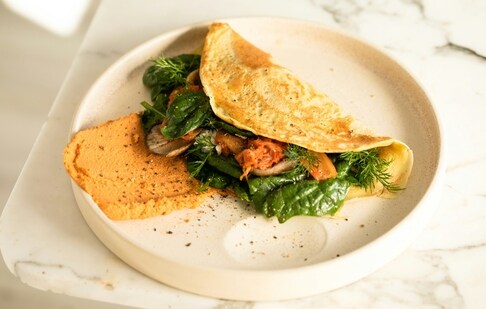 Chickpea flour wrap stuffed with greens and protein can make for a healthy and fulfilling lunch (unsplash)