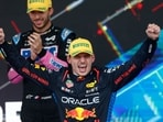 Red Bull Racing's Dutch driver Max Verstappen celebrates at the podium after winning the Formula One Sao Paulo Grand Prix