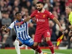 Liverpool's Mohamed Salah, right, challenges for the ball with Brighton's Pervis Estupinan. (AP Photo/Jon Super)