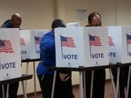 Voters cast their votes during early voting in the U.S. presidential election at a polling station in Detroit, Michigan, U.S. November 3, 2024.  REUTERS/Rebecca Cook