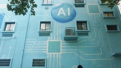 A woman walks past a building whose exterior wall was painted to look like a circuit board with an AI logo in Hangzhou, in China's eastern Zhejiang province. (AFP) A woman walks past a building whose exterior wall was painted to look like a circuit board with an AI logo in Hangzhou, in China's eastern Zhejiang province. (AFP)