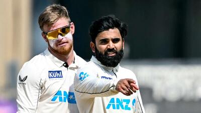 New Zealand's Ajaz Patel (R) gestures as Glenn Phillips watches during the Mumbai Test on Sunday. (AFP) New Zealand's Ajaz Patel (R) gestures as Glenn Phillips watches during the Mumbai Test on Sunday. (AFP)