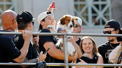 Shohei Ohtani of the Los Angeles Dodgers celebrates on the bus with his dog Decoy during the 2024 World Series Championship parade in Los Angeles, California. (AFP) Shohei Ohtani of the Los Angeles Dodgers celebrates on the bus with his dog Decoy during the 2024 World Series Championship parade in Los Angeles, California. (AFP)