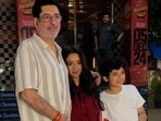 Rupali Ganguly, Ashwin Verma and their son pose outside a Mumbai theatre.