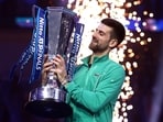 Serbia's Novak Djokovic celebrates with the trophy after winning the final against Italy's Jannik Sinner