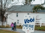 US Voters leave after casting their ballots on November 5, 2024 in Whitefield, New Hampshire. Americans cast their ballots today in the presidential race between Donald Trump and Kamala Harris, as well as multiple state elections that will determine the balance of power in Congress.  