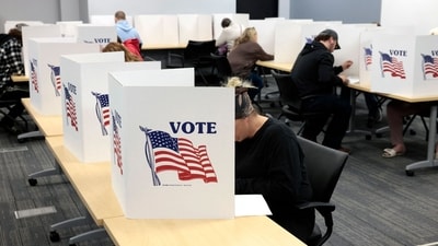 People cast their ballots on the last day of early voting for the general election in Michigan. (AFP) People cast their ballots on the last day of early voting for the general election in Michigan. (AFP)