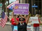 Beth Weinstein rallies in supporter of Yes on Amendment 4 regarding abortion in Florida outside of the polling place at the courthouse