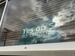 A sign in an apartment window in Bismarck, N.D., in support of a ballot initiative that would legalize recreational marijuana in the state. (AP Photo/Jack Dura)
