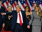Former US President and Republican presidential candidate Donald Trump gestures at supporters after speaking as he holds hands with former US First Lady Melania Trump during an election night event at the West Palm Beach Convention Center in West Palm Beach, Florida, early on November 6. (Photo by Jim WATSON / AFP)
