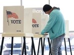 A person votes during the 2024 U.S. Presidential Election on Election Day in the showroom of Superior Honda of Omaha in Omaha, Nebraska, U.S.
