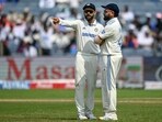 India's Virat Kohli talks with his captain Rohit Sharma (R) during the New Zealand series.
