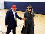 Republican presidential nominee former President Donald Trump escorts his wife Melania Trump at the polling place in the Morton and Barbara Mandel Recreation Center on Election Day, on November 05, 2024 in Palm Beach, Florida. 