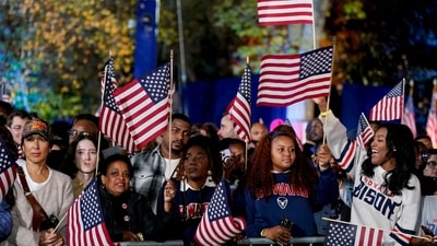 Attendees wave American flags during an election night event with US Vice President Kamala Harris, not pictured, in Washington, DC, US, on Tuesday, Nov. 5, 2024. The 2024 presidential campaign was marked by two assassination attempts, a candidate switch, divisive rhetoric and warnings about the fate of democracy. Photographer: Al Drago/Bloomberg (Bloomberg)