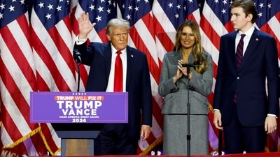 Former US President Donald Trump, from left, former US First Lady Melania Trump, and their son Barron Trump during an election night event at the Palm Beach Convention Center in West Palm Beach, Florida, US, on Wednesday, Nov. 6, 2024.. Photographer: Eva Marie Uzcategui/Bloomberg (Bloomberg) Former US President Donald Trump, from left, former US First Lady Melania Trump, and their son Barron Trump during an election night event at the Palm Beach Convention Center in West Palm Beach, Florida, US, on Wednesday, Nov. 6, 2024.. Photographer: Eva Marie Uzcategui/Bloomberg (Bloomberg)