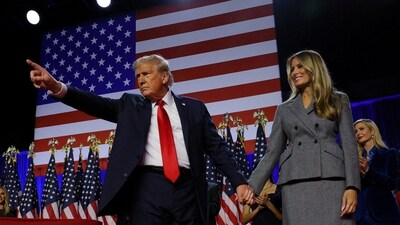 Donald Trump gestures as he holds hands with his wife Melania during his rally, at the Palm Beach County Convention Center in West Palm Beach, Florida. (Reuters)