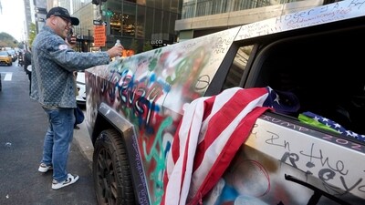 A Trump 2024 decorated Tesla Cybertruck is parked adjacent to Trump Tower, on New York's Fifth Avenue, Tuesday, Nov. 5, 2024. (Richard Drew / AP) A Trump 2024 decorated Tesla Cybertruck is parked adjacent to Trump Tower, on New York's Fifth Avenue, Tuesday, Nov. 5, 2024. (Richard Drew / AP)