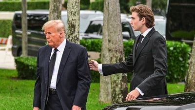 Former US President Donald Trump and his son Barron Trump attend the funeral of former first lady Melania Trump's mother Amalija Knavs, (AFP)