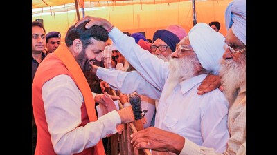 Nayab Saini takes blessing from an elderly man during a public meeting, at Dabkheda village, Ladwa, in Kurukshetra on Wednesday. (Nayab Saini-X) Nayab Saini takes blessing from an elderly man during a public meeting, at Dabkheda village, Ladwa, in Kurukshetra on Wednesday. (Nayab Saini-X)