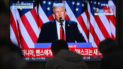 People sit near a television broadcasting footage of former US President and Republican presidential candidate Donald Trump as he speaks during an election night event, at a train station in Seoul on Wednesday. (AFP) People sit near a television broadcasting footage of former US President and Republican presidential candidate Donald Trump as he speaks during an election night event, at a train station in Seoul on Wednesday. (AFP)