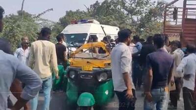 The overloaded autorickshaw toppled over when the driver swerved sharply to avoid hitting the motorcycle, but a truck hit it from the opposite side The overloaded autorickshaw toppled over when the driver swerved sharply to avoid hitting the motorcycle, but a truck hit it from the opposite side