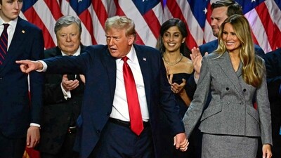 Former US President and Republican presidential candidate Donald Trump gestures at supporters after speaking as he holds hands with former US First Lady Melania Trump during an election night event at the West Palm Beach Convention Center in West Palm Beach, Florida, early on November 6. (Photo by Jim WATSON / AFP) (AFP) Former US President and Republican presidential candidate Donald Trump gestures at supporters after speaking as he holds hands with former US First Lady Melania Trump during an election night event at the West Palm Beach Convention Center in West Palm Beach, Florida, early on November 6. (Photo by Jim WATSON / AFP) (AFP)