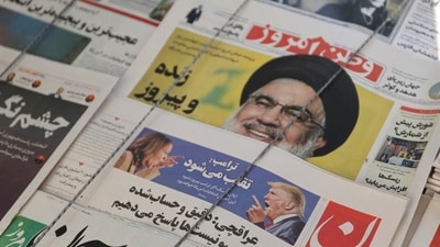 A newspaper with a picture of Republican presidential nominee and former U.S. President Donald Trump and Democratic presidential nominee U.S. Vice President Kamala Harris is seen in Tehran, Iran November 6, 2024. (Majid Asgaripour/WANA (West Asia News Agency) via Reuters)