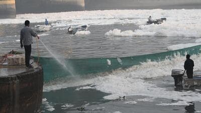 Workers spray chemicals to dissolve the toxic foam in the Yamuna on the eve of Chhath Puja, at Kalindi Kunj on Wednesday. (Arvind Yadav/HT Photo) Workers spray chemicals to dissolve the toxic foam in the Yamuna on the eve of Chhath Puja, at Kalindi Kunj on Wednesday. (Arvind Yadav/HT Photo)