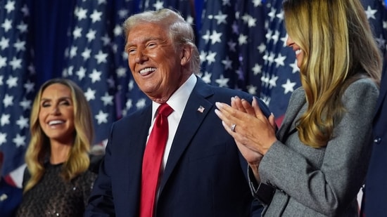 Republican presidential nominee former President Donald Trump stands on stage with former first lady Melania Trump, as Lara Trump watches, at an election night watch party at the Palm Beach Convention Center, Wednesday, Nov. 6, 2024, in West Palm Beach, Fla. (AP Photo/Evan Vucci)