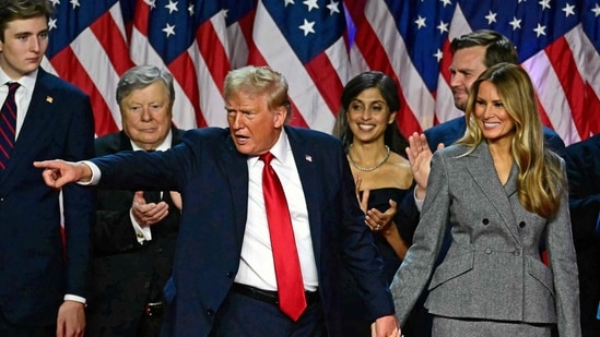 Former US President and Republican presidential candidate Donald Trump gestures at supporters after speaking as he holds hands with former US First Lady Melania Trump during an election night event at the West Palm Beach Convention Center in West Palm Beach, Florida, early on November 6, 2024. (AFP)
