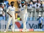 India's Ravindra Jadeja (L) and captain Rohit Sharma in action.
