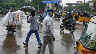 A traffic police personnel manages traffic during rain in Chennai on Thursday. (PTI) A traffic police personnel manages traffic during rain in Chennai on Thursday. (PTI)