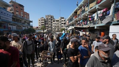 Palestinians gather to receive aid distributed by UNRWA, the U.N. agency helping Palestinian refugees, in Nusairat refugee camp, Gaza, Tuesday, Nov. 5, 2024. (AP Photo/Abdel Kareem Hana) (AP)