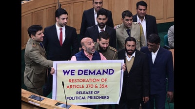 Langate MLA Khurshid Ahmad Sheikh displaying the banner in support of the resolution to restore the Jammu and Kashmir's special status during the ongoing assembly session in Srinagar. (Waseem Andrabi/HT) Langate MLA Khurshid Ahmad Sheikh displaying the banner in support of the resolution to restore the Jammu and Kashmir's special status during the ongoing assembly session in Srinagar. (Waseem Andrabi/HT)