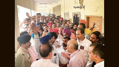 Railways officials trying to placate the agitating workers outside senior divisional electric engineer’s office at the Electric Loco Shed in Ludhiana on Thursday. (HT Photo) Railways officials trying to placate the agitating workers outside senior divisional electric engineer’s office at the Electric Loco Shed in Ludhiana on Thursday. (HT Photo)