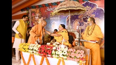 UP CM Yogi Adityanath attending the Shrimad Bhagwat Katha at home of ex-minister Mahendra Singh in Pratapgarh on Thursday. (HT Photo)