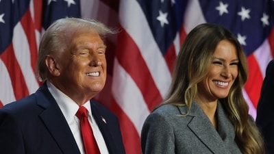 Republican presidential nominee and former U.S. President Donald Trump smiles accompanied by Melania Trump, after speaking following early results from the 2024 U.S. presidential election in Palm Beach County Convention Center, in West Palm Beach, Florida, U.S., November 6, 2024. REUTERS/Carlos Barria