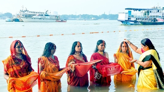 Vermilion being applied to a devotee on the banks of Ganga river during Chhath Puja festival, in Kolkata. Chhath Puja honors the Sun God and Chhathi Maiya.(ANI)