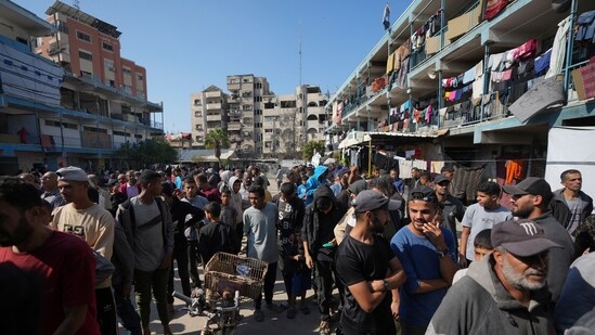 Palestinians gather to receive aid distributed by UNRWA, the U.N. agency helping Palestinian refugees, in Nusairat refugee camp, Gaza, Tuesday, Nov. 5, 2024. (AP Photo/Abdel Kareem Hana) (AP)