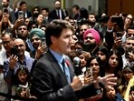 Attendees use their phones to record Canadian Prime Minister Justin Trudeau as he delivers remarks at the Diwali and Bandi Chhor Divas on the Hill celebration in Ottawa, Ontario, ob Monday, 