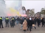 In this image taken from video, police stand guard as Maccabi Tel Aviv supporters light flares at the Dam square, in Amsterdam (AP Photo InterVision) In this image taken from video, police stand guard as Maccabi Tel Aviv supporters light flares at the Dam square, in Amsterdam (AP Photo InterVision)