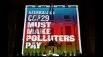 FILE PHOTO: Climate activists project a message onto the Embassy of Azerbaijan ahead of COP29 climate talks, in London, Britain, November 7, 2024. REUTERS/Chris J. Ratcliffe/File Photo (REUTERS)
