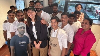 Virat Kohli and Anushka Sharma with Mumbai cafe staff Virat Kohli and Anushka Sharma with Mumbai cafe staff