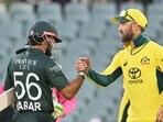 Australia's Glenn Maxwell (R) congratulates Pakistan's Babar Azam. (Photo by Brenton EDWARDS / AFP) 