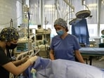 Medical staff at the septic surgery department of the Mechnikov Hospital in Dnipro check a patient on September 26, 2024, amid the Russian invasion of Ukraine. Direct combat and aerial strikes have triggered a rise in patients suffering from traumatic wounds, who have overwhelmed understaffed hospitals. The Dnipro Mechnikov Hospital saw its workload increase tenfold, said chief surgeon Sergiy Kosulnykov. (Photo by Genya SAVILOV / AFP) Medical staff at the septic surgery department of the Mechnikov Hospital in Dnipro check a patient on September 26, 2024, amid the Russian invasion of Ukraine. Direct combat and aerial strikes have triggered a rise in patients suffering from traumatic wounds, who have overwhelmed understaffed hospitals. The Dnipro Mechnikov Hospital saw its workload increase tenfold, said chief surgeon Sergiy Kosulnykov. (Photo by Genya SAVILOV / AFP)