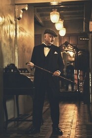 This look exudes a vintage, Gatsby-inspired elegance. Kher sports a classic, textured three-piece suit paired with a crisp white shirt and a black bow tie, all by designer Pawan Sachdeva. Completing the look are a flat cap and a cane, adding a charm reminiscent of early 20th-century sophistication (Photo: Priyankk Nandwana) This look exudes a vintage, Gatsby-inspired elegance. Kher sports a classic, textured three-piece suit paired with a crisp white shirt and a black bow tie, all by designer Pawan Sachdeva. Completing the look are a flat cap and a cane, adding a charm reminiscent of early 20th-century sophistication (Photo: Priyankk Nandwana)