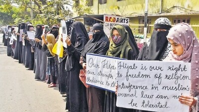 Women and girls holding placards stage a peaceful protest over the hijab ban imposed in the few colleges in Karnataka Women and girls holding placards stage a peaceful protest over the hijab ban imposed in the few colleges in Karnataka
