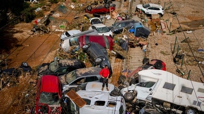 A man stands among flooded cars piled up in Valencia, Spain. (AP) A man stands among flooded cars piled up in Valencia, Spain. (AP)